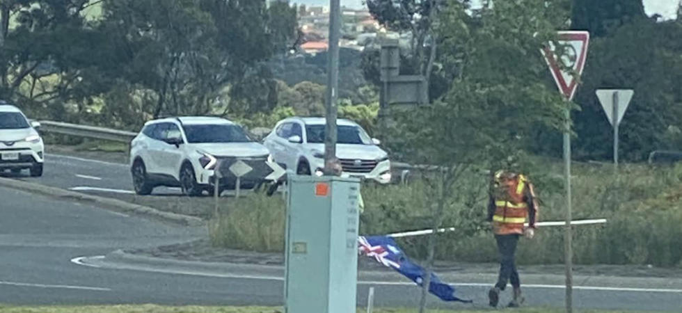 The national flag is removed from a Sunbury roundabout on Australia Day.