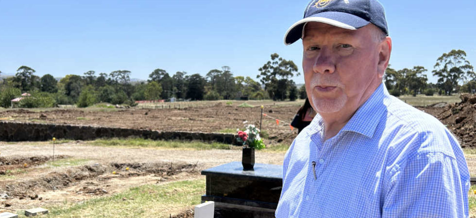 Dennis Ness at his son James' grave at Sunbury Cemetery.