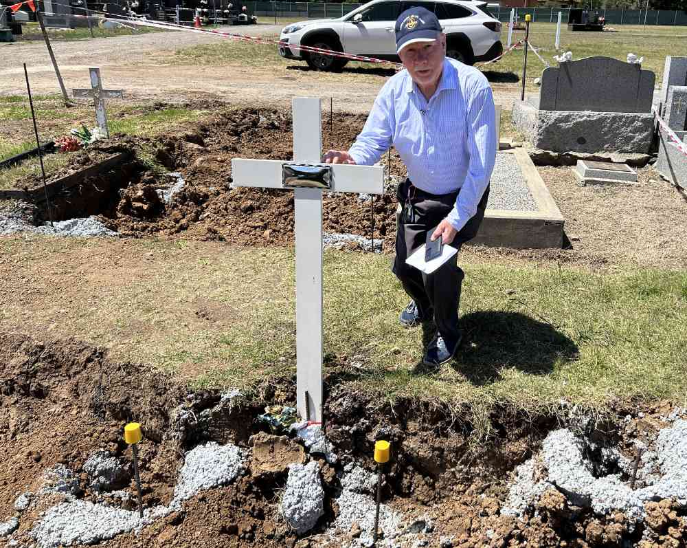 Dennis Ness at his son's (James) grave.