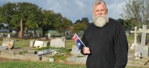 Dave White with one of the Australian flags he uses to mark the graves of former service personnel. Photo / Sunbury Life.
