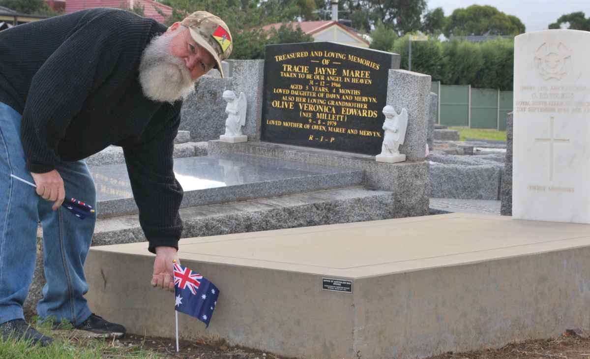 Dave White with one of the Australian flags he uses to mark the graves of former service personnel. Photo / Sunbury Life.