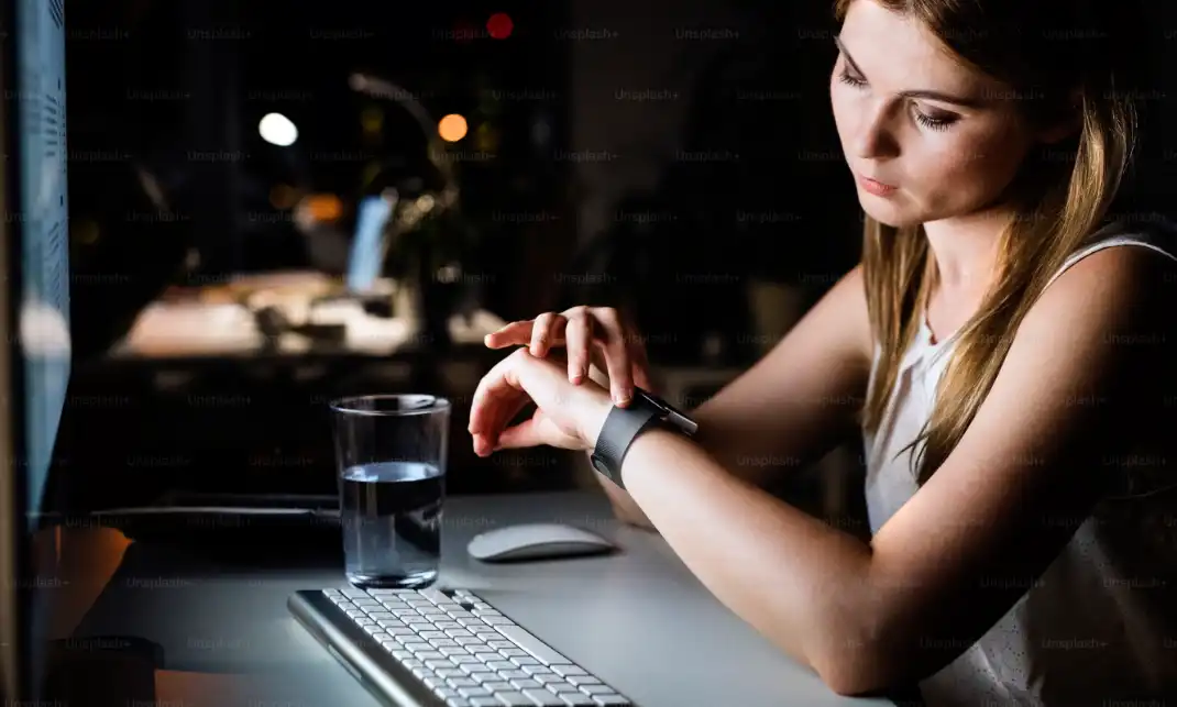 Waiting at a computer with a glass of water. Photo / Unsplash.