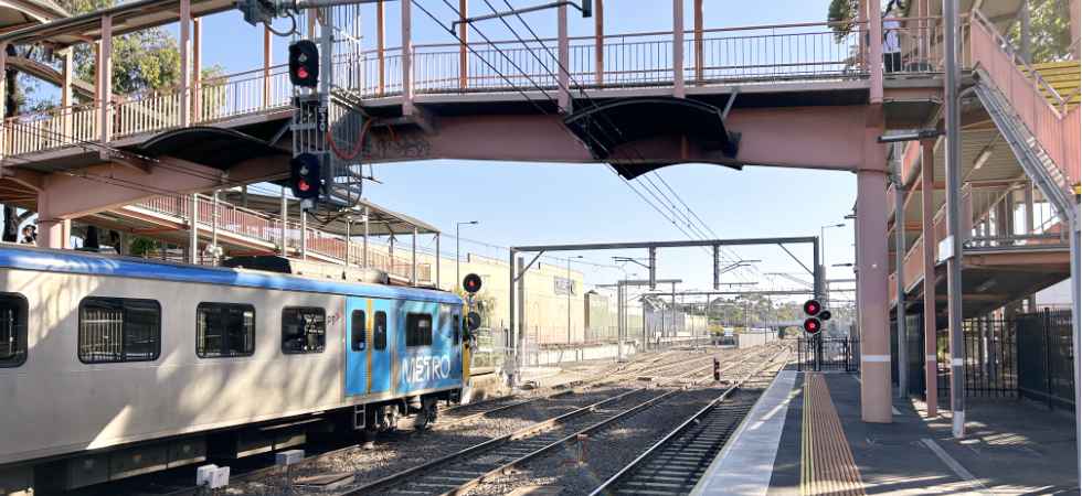 Sunbury Rail station platform with a metro train waiting to leave,