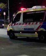 Ambulance with lights flashing at night.